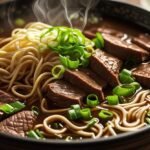 a bowl of soup with meat and noodles